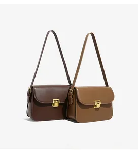 Detail view of brown and khaki leather crossbody bags with premium gold buckle and strap