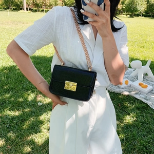 Classic black crocodile pattern crossbody bag with gold chain strap and metal lock detail