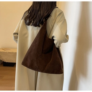Macro shot of large dark brown suede tote bag showing soft matte texture and minimalist design