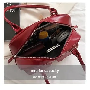 Spacious internal capacity of wine red leather handbag showing storage for daily essentials