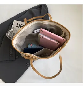 Spacious interior of camel tote bag with multi-layer pockets for daily essentials and devices