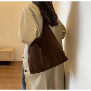Deep brown oversized matte suede shoulder bag shown as a stylish crossbody bucket style