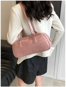 Pink Boston shoulder bag in glossy leather shown on model for daily lifestyle usage
