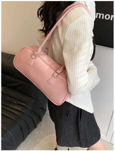Pink PU leather Boston bag shown on shoulder in a stylish indoor lifestyle setting