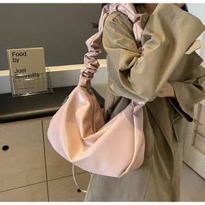 Close-up of pleated shoulder strap on large dusky pink tote bag with soft leather finish