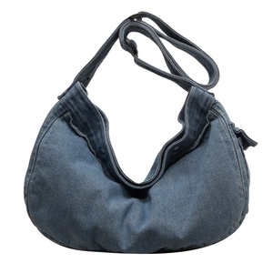 Washed blue denim crescent messenger bag with adjustable wide strap and metal snap button