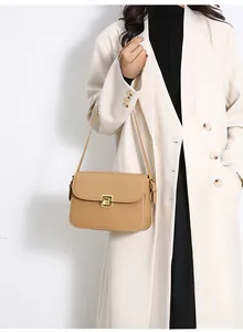 Khaki crossbody bag featuring a smooth leather finish and a golden metal clasp