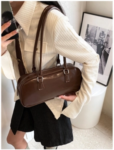 Mirror selfie showing the scale of a dark brown glossy Boston bag with silver hardware