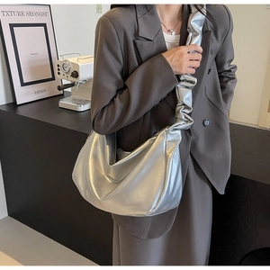 Detail of silver metallic hobo bag with trendy scrunchie shoulder strap and large capacity
