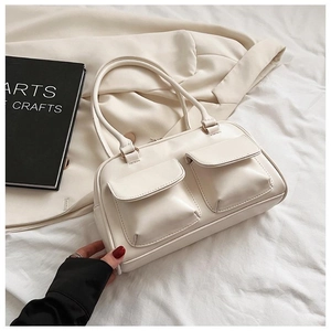 Detail of cream white rectangular handbag with dual front pockets on blazer background