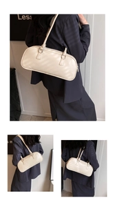 Detailed views of a creamy white minimalist faux leather Boston bag with silver hardware