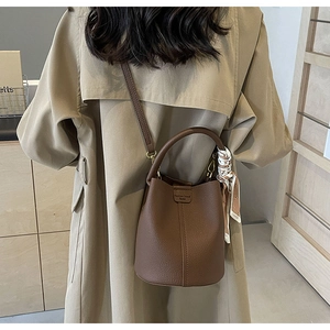 Brown lychee leather bucket bag detail with floral scarf handle and Fashion trend print