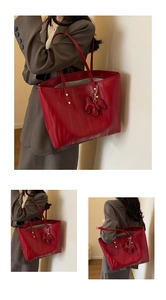 Detail of red tote bag featuring wave textures, golden rivets and a cute dog charm