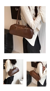 Detail view of brown vintage leather baguette bag with silver hardware and shoulder straps