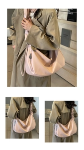 Pink pleated hobo bag detail with metal zipper and decorative pendant on the shoulder strap