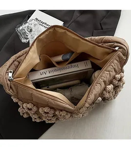 Internal view of the quilted tote bag showing a large main pocket and zipper pocket