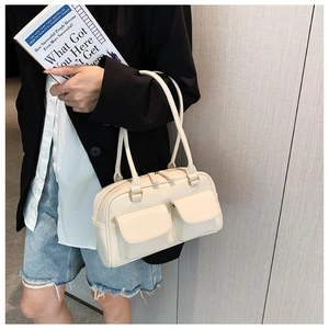 Close-up of a cream-white Boston shoulder bag featuring double front flap pockets