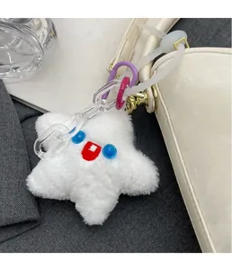 Plush white star bag charm with embroidered eye details and acrylic chain accessory