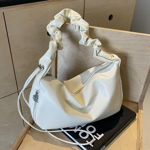 Minimalist beige ruched leather tote bag with stylish pleated handle and zipper closure