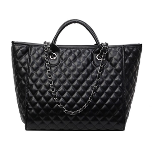 Classic black quilted tote bag with diamond pattern and chain strap on white background