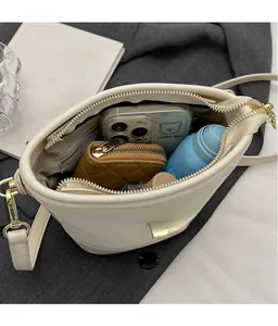 Internal view of cream bucket bag showing large capacity for phone and wallet