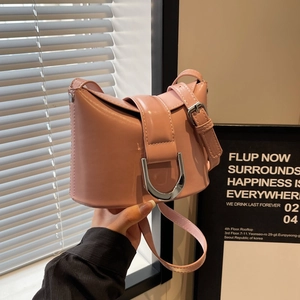 Pink bucket shoulder bag with silver D-ring buckle and adjustable strap for women