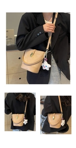 Detail of apricot bucket bag featuring gold twist lock and cute plush star charm