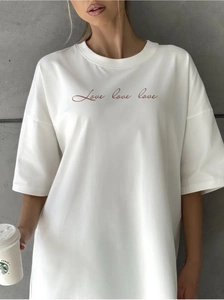 Close-up of white oversized cotton T-shirt featuring red Love love love script embroidery