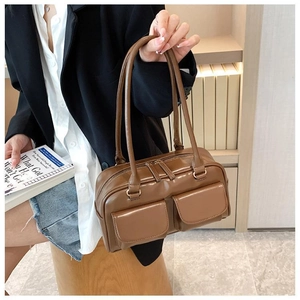 Brown PU leather tote bag with dual front pockets and long handles for shoulder wear