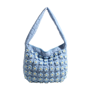 Light blue quilted cloud bag with 3D floral decorations and wide shoulder strap
