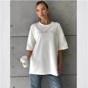 White cotton t-shirt with red Love script paired with navy blue straight-leg jeans