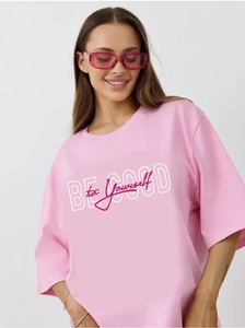 Detail view of pink oversized cotton T-shirt featuring Be Good to Yourself text print