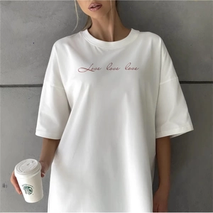 White loose-fit cotton T-shirt with red Love script and crew neck in casual style