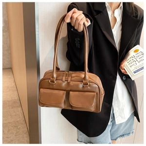 Retro brown PU leather tote bag with double front flap pockets shown with a black blazer