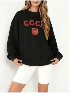 Close-up of red CCCP logo and hammer and sickle emblem on black crewneck sweatshirt
