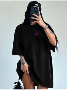 Close-up of black oversized cotton t-shirt featuring a red flame logo on the chest