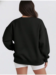 Back view of a black oversized drop shoulder sweatshirt with ribbed crewneck for women