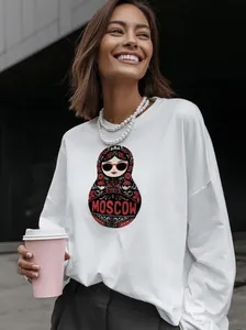 Detail of white cotton long-sleeved T-shirt with Moscow matryoshka doll print and crew neck