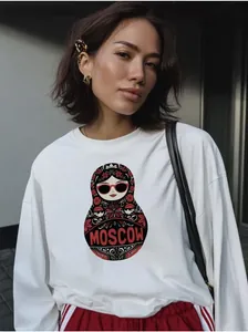 Close-up of white cotton long sleeve sweatshirt with Moscow nesting doll print graphic