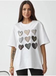 Detail of white oversized cotton T-shirt featuring a grid of minimalist heart prints