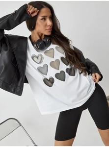Detail of white cotton T-shirt with heart print worn under a black leather biker jacket