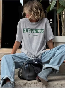 Detail of grey cotton T-shirt featuring green HAPPINESS text and street style print