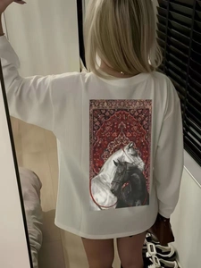 Detail of artistic horse print on back of white oversized 100% cotton long-sleeve tee