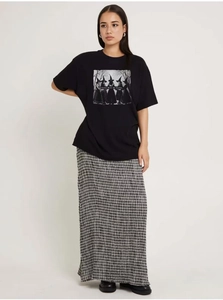 Close-up of Girls Will Be Girls print on oversized black cotton T-shirt with witch graphics