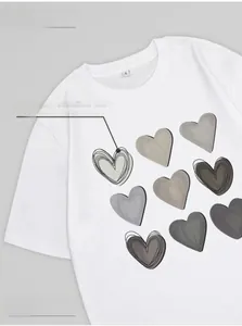 Detail of white cotton T-shirt featuring nine gradient heart prints and an S size label