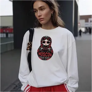 White cotton crewneck sweatshirt with Moscow matryoshka print in urban outdoor setting