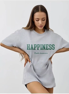 Detailed macro view of heavy cotton fabric and green letter print on grey t-shirt