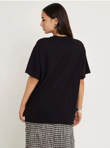 Rear view of oversized black cotton T-shirt featuring dropped shoulders and round neck