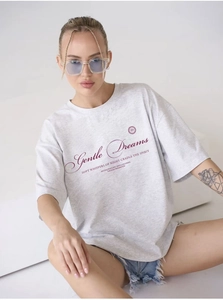 Detail of light grey cotton oversized t-shirt with red Gentle Dreams graphic text