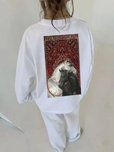 Detailed back view of a white cotton sweatshirt featuring a stylish horse and carpet print